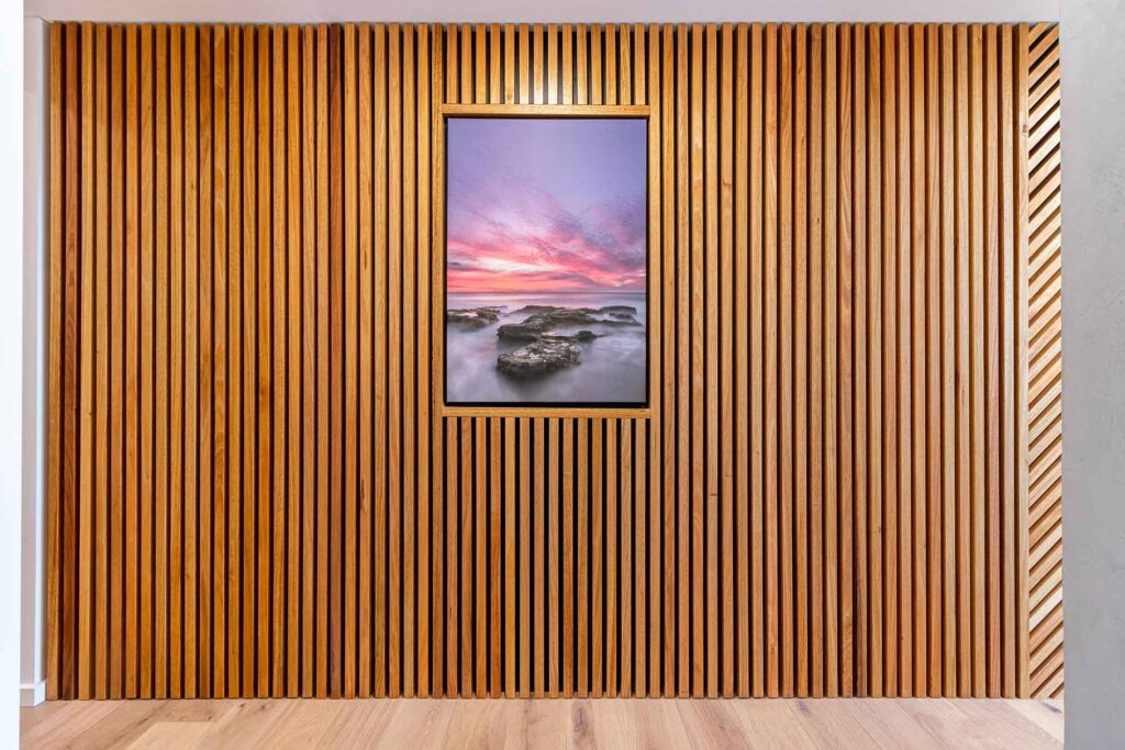 A unique timber feature wall, showcasing a piece of art. This beautiful hallways belongs to a sustainable house build in Coogee, WA.