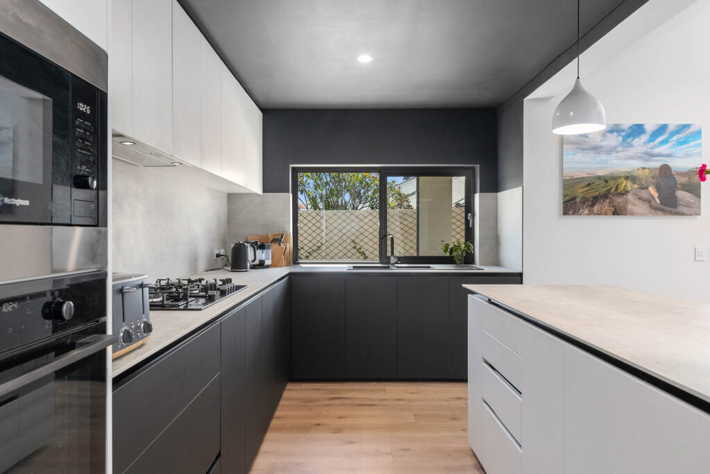 Unique black and white kitchen with a black painted ceiling. A feature of this beautiful sustainable home build in Perth.