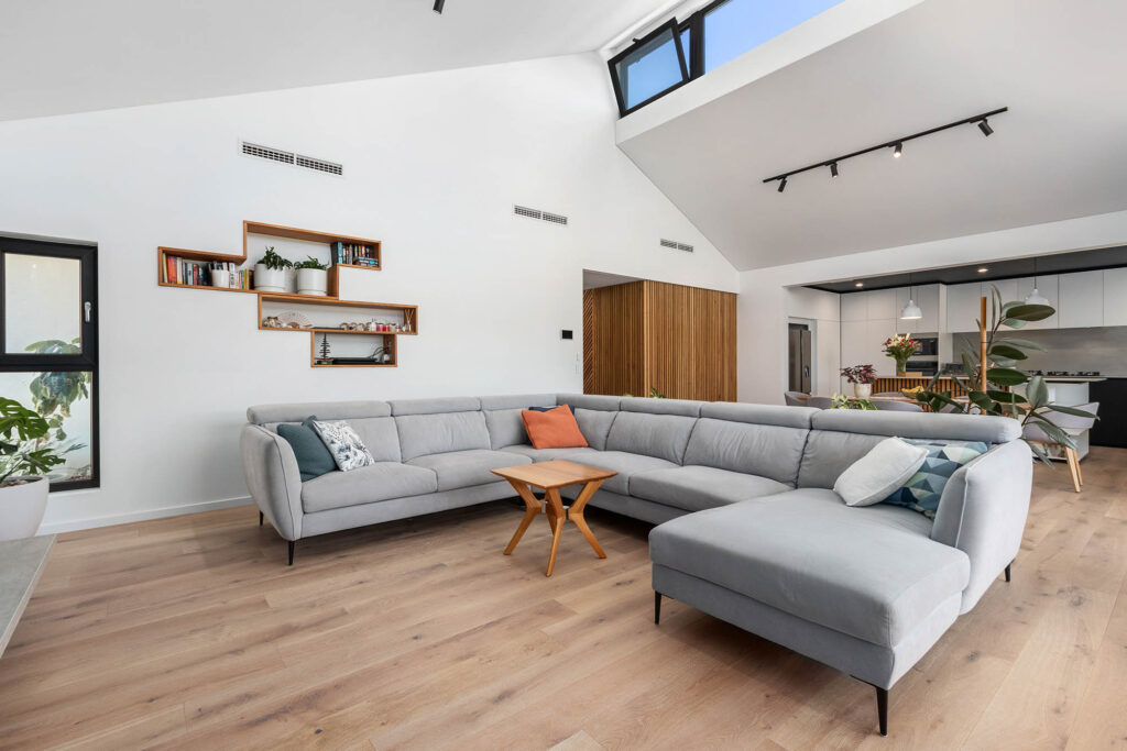 Beautiful living area with a raked ceiling and clerestory windows in a newly built sustainable home in Perth.